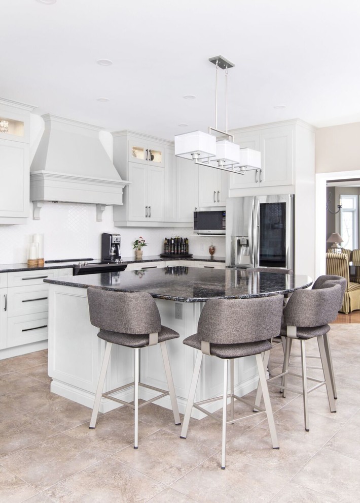 Enclosed kitchen - large transitional u-shaped ceramic tile and beige floor enclosed kitchen idea with a double-bowl sink, recessed-panel cabinets, gray cabinets, granite countertops, stainless steel appliances, an island and black countertops