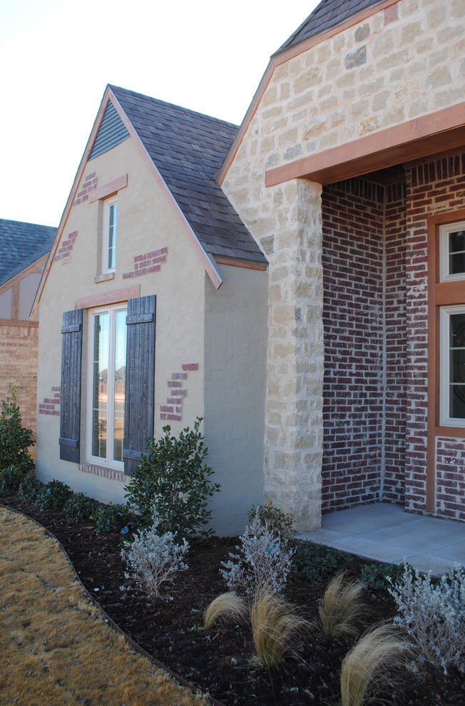 Photo of a large eclectic one-storey brick red exterior in Austin with a gable roof.