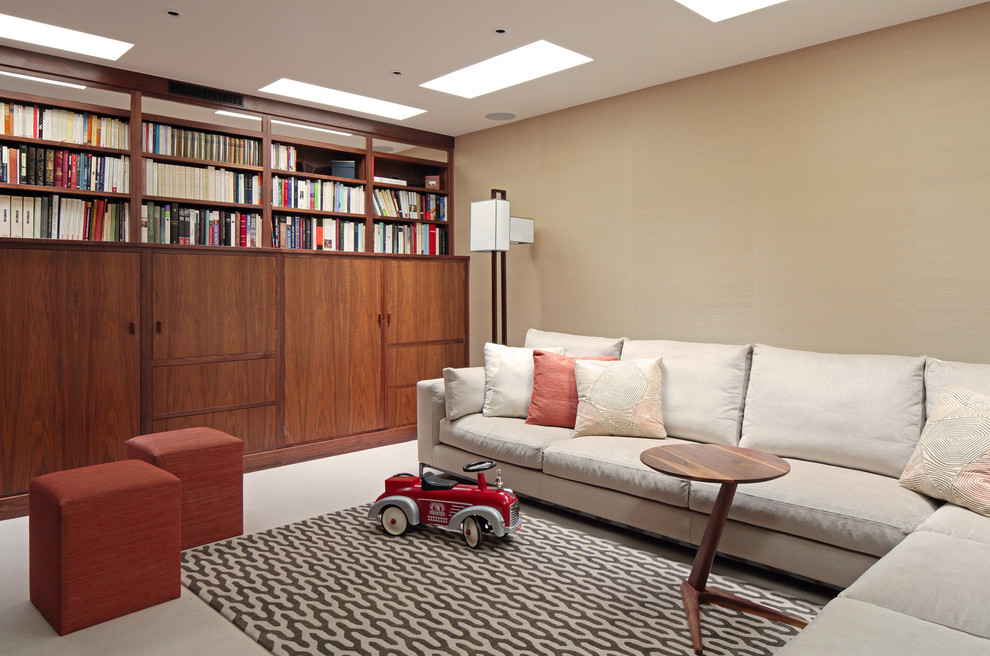 Contemporary enclosed living room in Other with a library and beige walls.