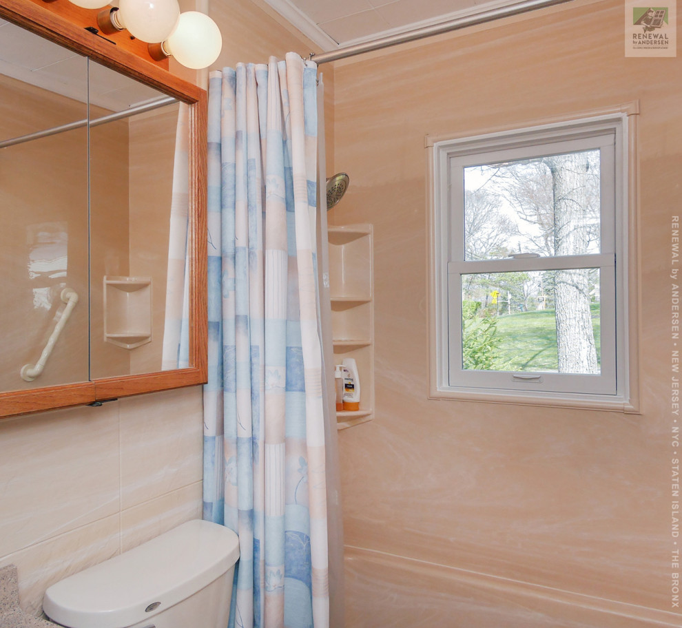 Photo of a mid-sized bathroom in New York with medium wood cabinets, an alcove tub, a shower/bathtub combo, a two-piece toilet, beige walls, an undermount sink, engineered quartz benchtops, white floor, a shower curtain, grey benchtops, a built-in vanity, recessed and panelled walls.