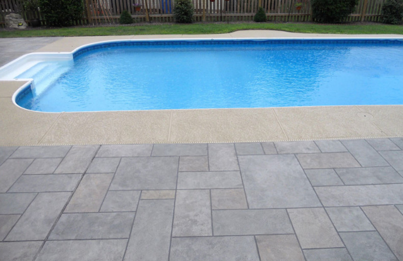 Mid-sized backyard concrete paver and custom-shaped natural pool house photo