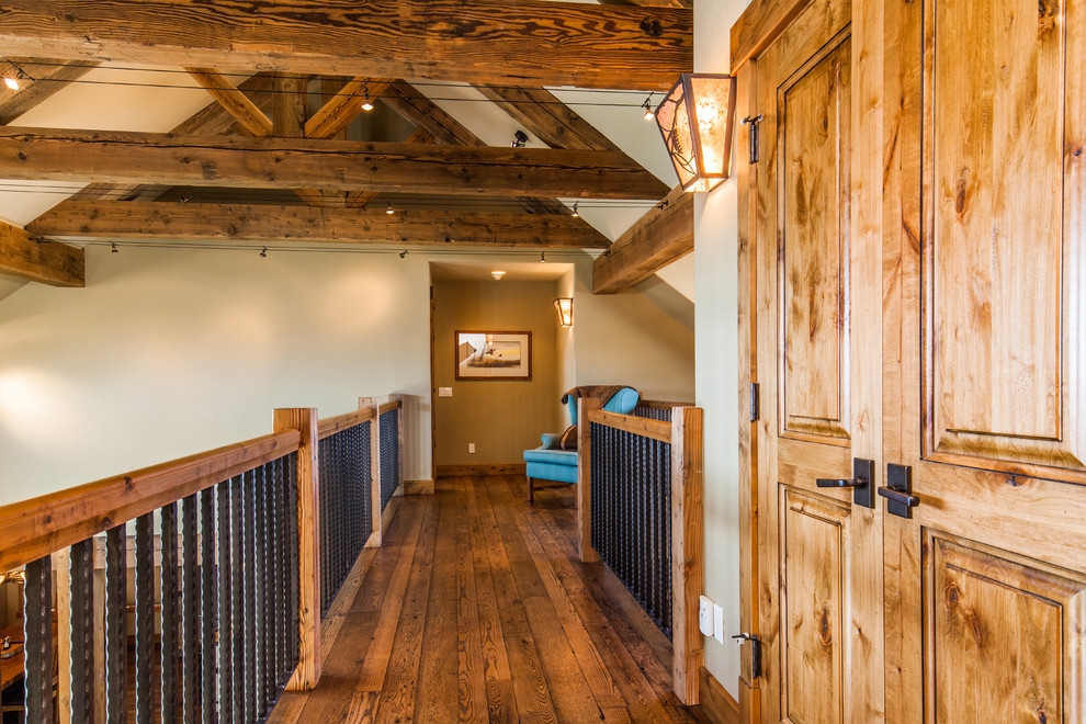 Example of a mid-sized mountain style medium tone wood floor hallway design with beige walls