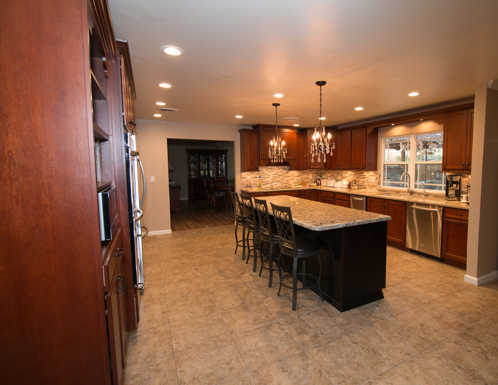 Example of a large transitional u-shaped porcelain tile kitchen design with an undermount sink, flat-panel cabinets, medium tone wood cabinets, quartz countertops, beige backsplash, mosaic tile backsplash, stainless steel appliances and an island