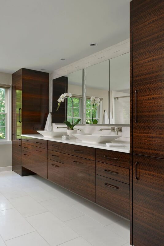 Contemporary bathroom in Charleston with flat-panel cabinets, brown cabinets, a wall-mount toilet, multi-coloured tile, grey walls, marble floors, a vessel sink, engineered quartz benchtops, white floor, a sliding shower screen, white benchtops, an enclosed toilet, a double vanity and a floating vanity.
