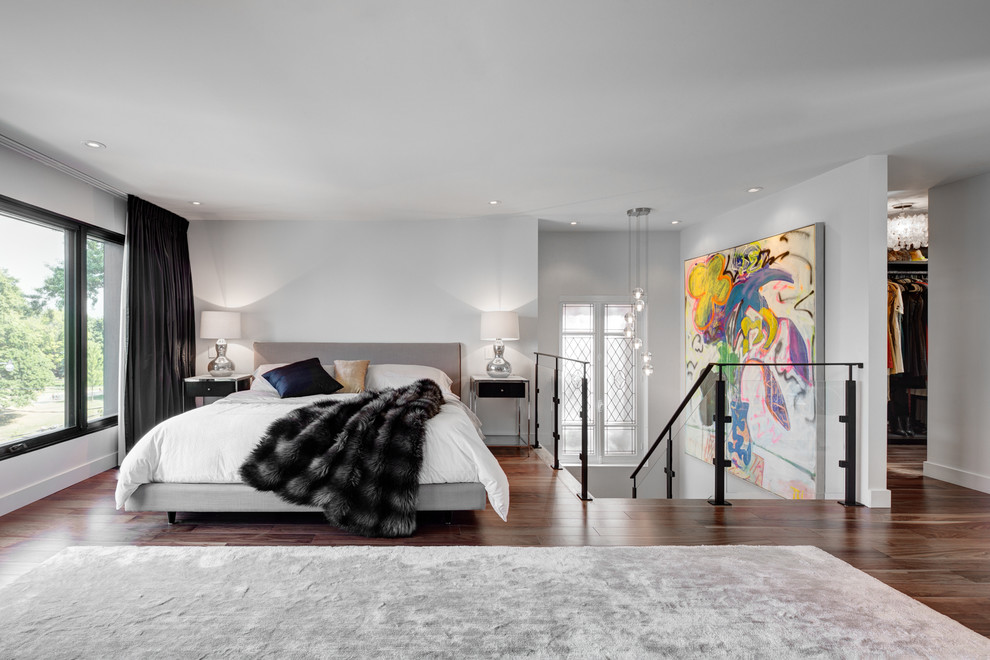 This is an example of a mid-sized contemporary master bedroom in Toronto with white walls, dark hardwood floors, a ribbon fireplace and a tile fireplace surround.