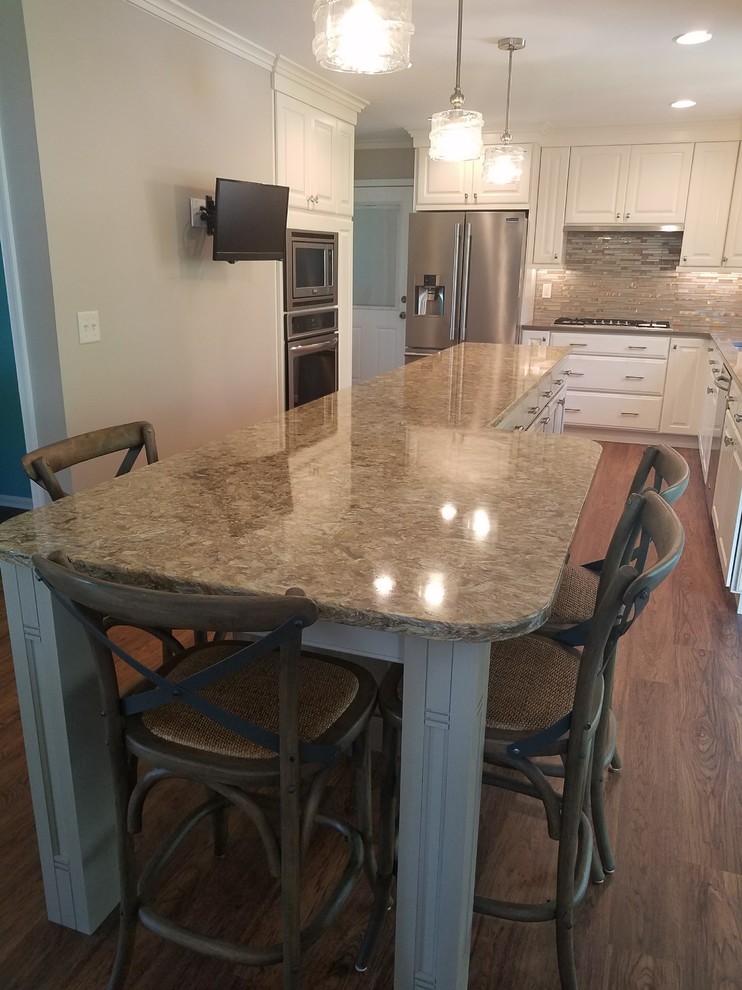 Open concept kitchen - mid-sized transitional l-shaped dark wood floor open concept kitchen idea in Baltimore with an undermount sink, raised-panel cabinets, white cabinets, granite countertops, metallic backsplash, matchstick tile backsplash, stainless steel appliances and an island