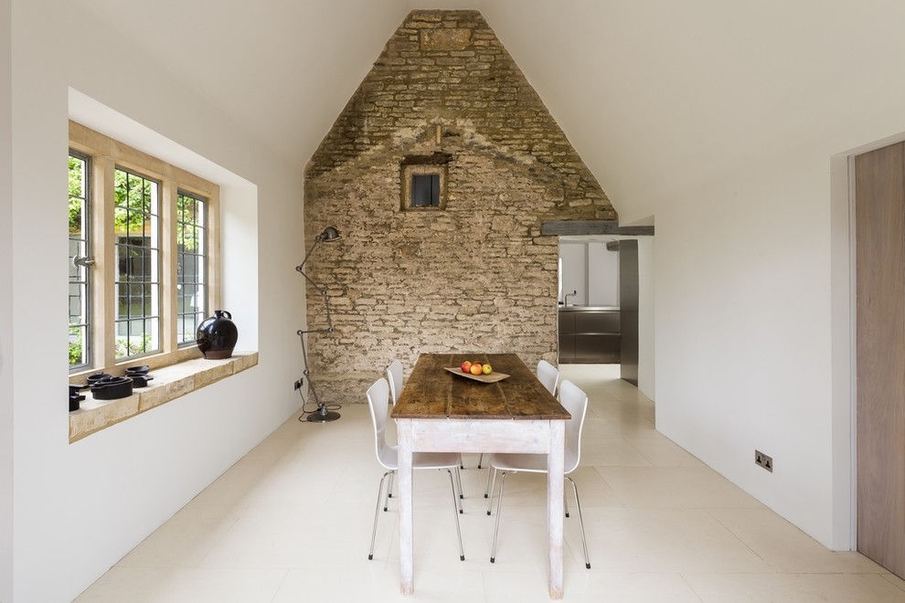 Inspiration for a contemporary dining room in Gloucestershire with limestone floors.
