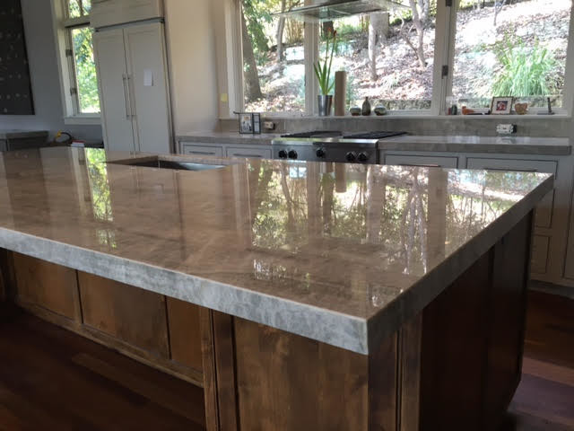 Example of a mid-sized transitional single-wall medium tone wood floor and gray floor kitchen design in Austin with recessed-panel cabinets, white cabinets, an island, a double-bowl sink, marble countertops, stainless steel appliances and gray countertops