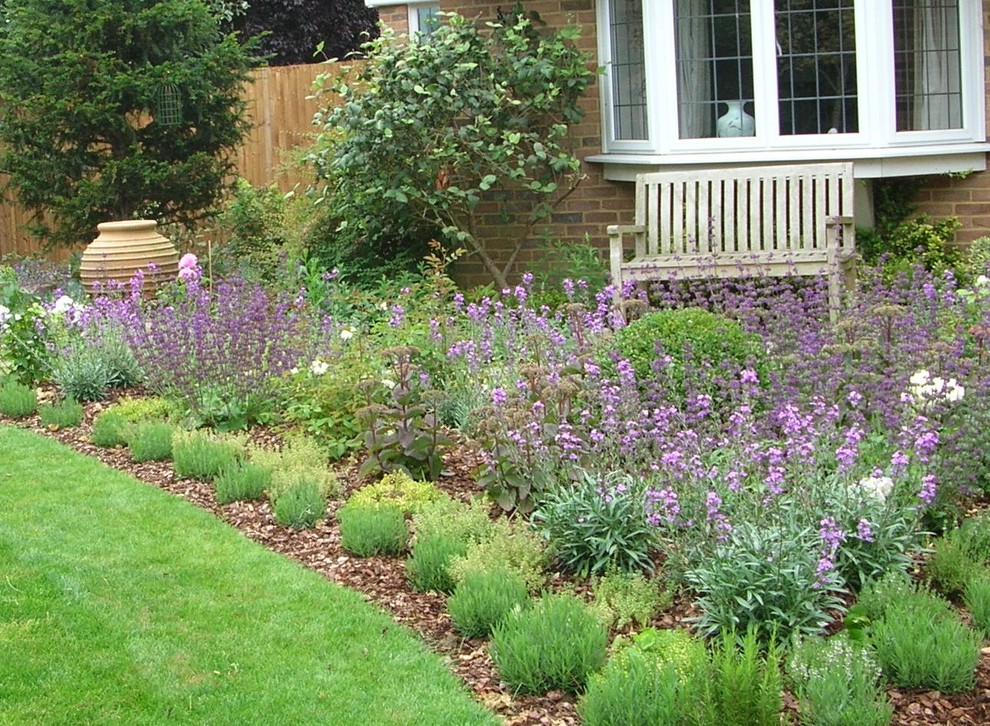 This is an example of a small mediterranean front yard full sun formal garden for summer in Surrey with a garden path.