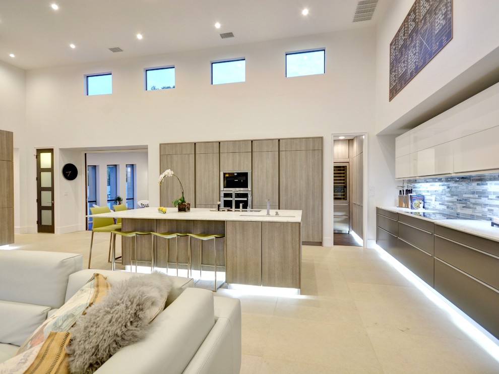 Photo of a contemporary l-shaped open plan kitchen in Austin with flat-panel cabinets, grey cabinets, grey splashback and with island.