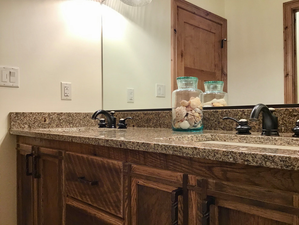 Example of a mid-sized mountain style 3/4 bathroom design with brown cabinets, quartz countertops and brown countertops