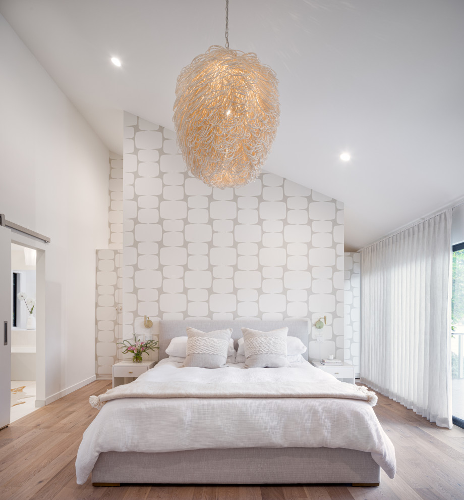 Design ideas for a contemporary bedroom in Portland with grey walls, medium hardwood flooring, brown floors, a vaulted ceiling and wallpapered walls.