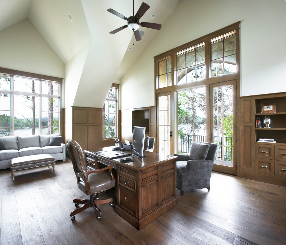 Huge elegant freestanding desk medium tone wood floor study room photo with no fireplace