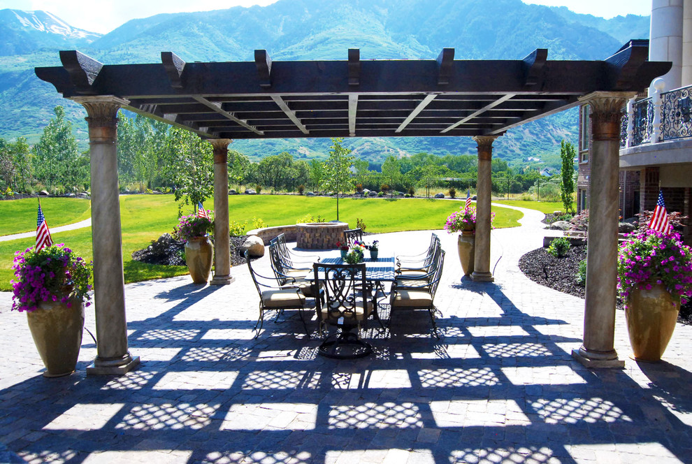 Inspiration for an expansive modern backyard patio in Salt Lake City with a pergola and concrete pavers.