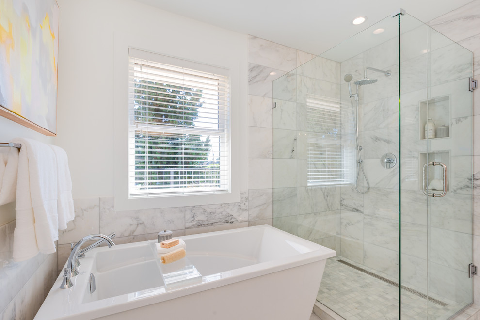 Design ideas for a transitional master bathroom in Vancouver with shaker cabinets, a freestanding tub, a corner shower, a two-piece toilet, white tile, marble, white walls, marble floors, an undermount sink, white floor and a hinged shower door.