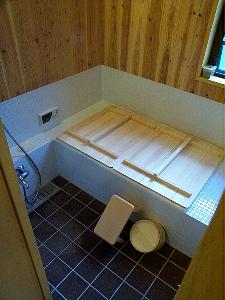 This is an example of a mid-sized modern master bathroom in Tokyo with furniture-like cabinets, white cabinets, a drop-in tub, a one-piece toilet, white tile, mosaic tile, white walls, cork floors, a drop-in sink, solid surface benchtops, brown floor, white benchtops, a single vanity, a built-in vanity, wood and wood walls.