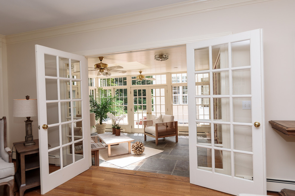 Inspiration for a large traditional sunroom in Boston with slate floors and a standard ceiling.