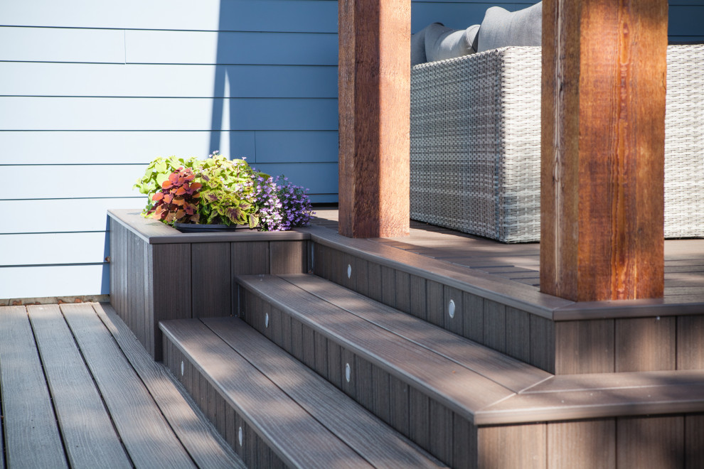 Deck - mid-sized contemporary backyard deck idea in Calgary with a pergola