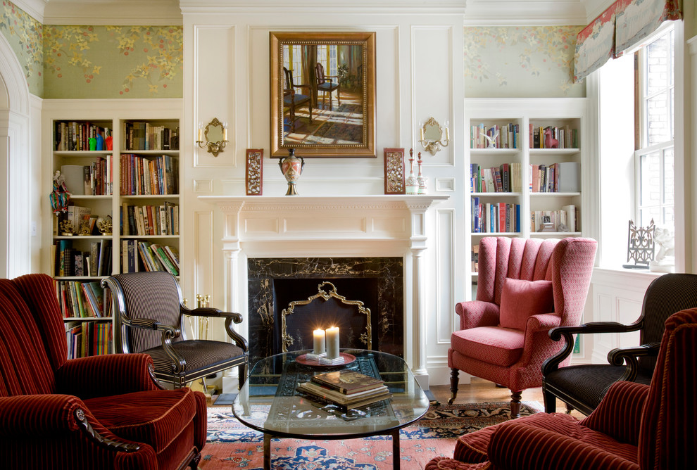This is an example of a mid-sized traditional formal enclosed living room in Boston with multi-coloured walls, a standard fireplace, a wood fireplace surround and medium hardwood floors.