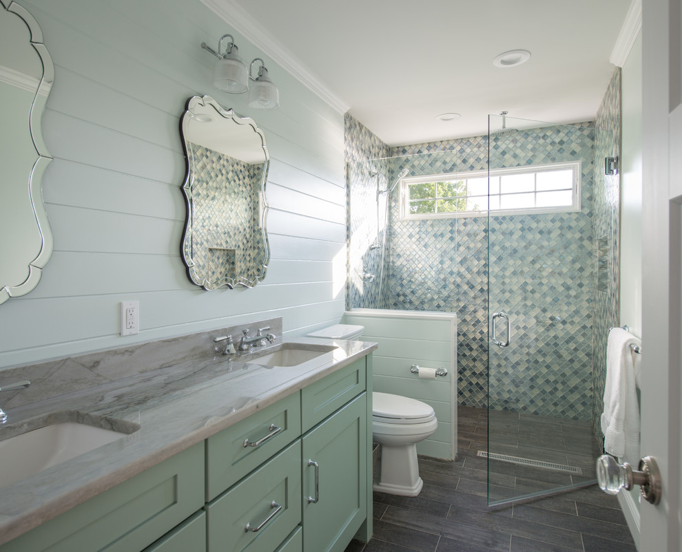 Inspiration for a large beach style master bathroom in Providence with raised-panel cabinets, turquoise cabinets, blue tile, green walls, grey floor and a hinged shower door.