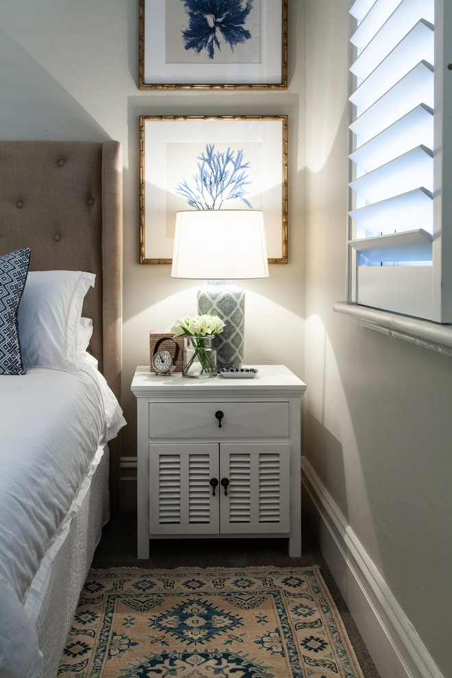 Photo of a small transitional guest bedroom in Melbourne with grey walls, carpet and grey floor.
