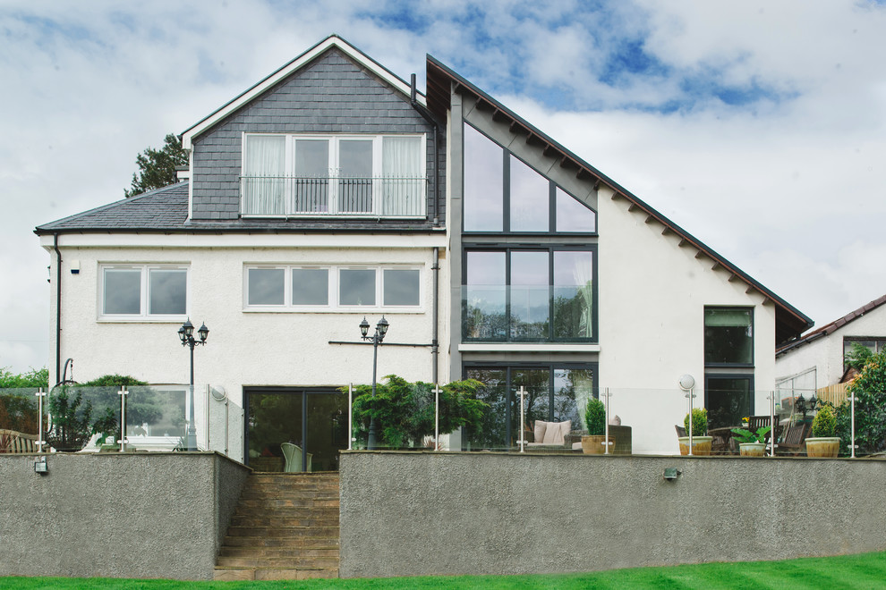 This is an example of a contemporary three-storey white exterior in Glasgow with mixed siding.