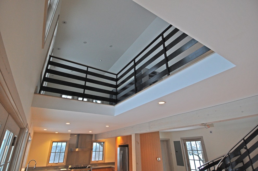 Staircase - large transitional wooden curved open and metal railing staircase idea in Boston
