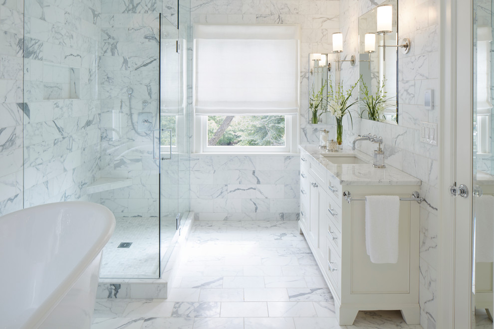 Photo of a mid-sized traditional master bathroom in Portland with recessed-panel cabinets, a freestanding tub, a corner shower, gray tile, white tile, marble floors, an undermount sink, marble benchtops, marble and a hinged shower door.