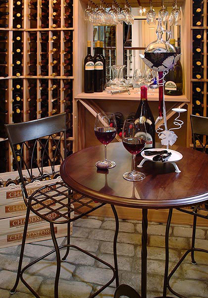 Photo of a mid-sized traditional wine cellar in Philadelphia with concrete floors, storage racks and grey floor.