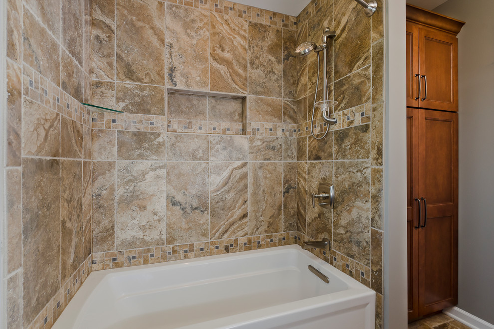 Alcove bathtub - mid-sized transitional kids' brown tile and porcelain tile porcelain tile alcove bathtub idea in Chicago with an undermount sink, flat-panel cabinets, medium tone wood cabinets, limestone countertops, a two-piece toilet and beige walls