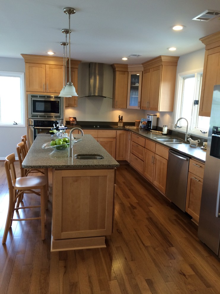Example of a mid-sized transitional u-shaped light wood floor open concept kitchen design with an undermount sink, shaker cabinets, light wood cabinets, quartz countertops, stainless steel appliances and an island
