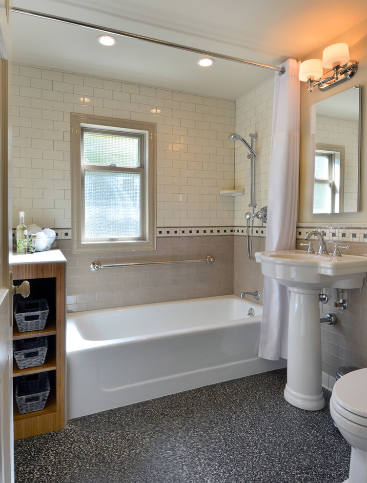 Design ideas for a mid-sized transitional master bathroom in Seattle with medium wood cabinets, an alcove tub, a shower/bathtub combo, a one-piece toilet, beige tile, porcelain tile, beige walls, linoleum floors, a pedestal sink, tile benchtops and black floor.