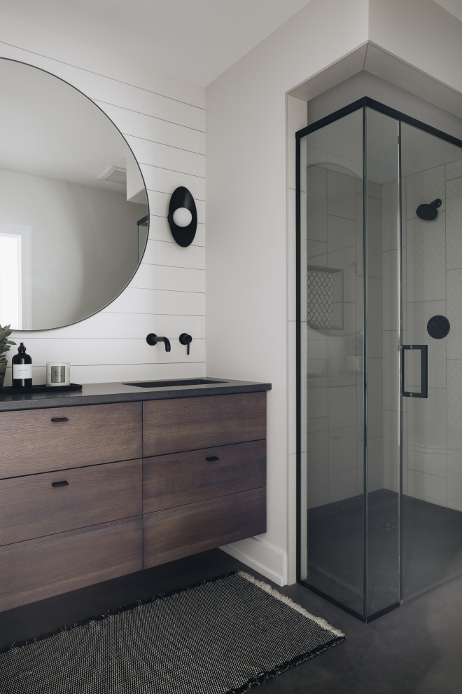 Beach style concrete floor, gray floor, double-sink and shiplap wall alcove shower photo in Grand Rapids with dark wood cabinets, white walls, an undermount sink, quartz countertops, a hinged shower door, black countertops, a floating vanity and flat-panel cabinets