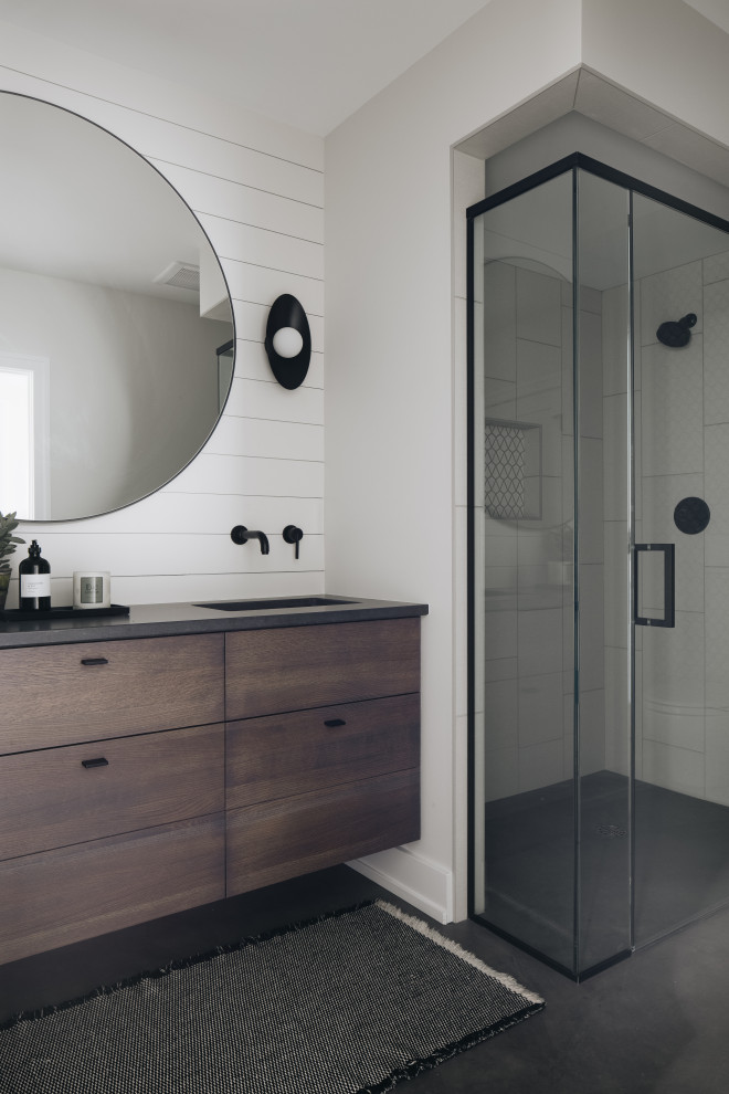 Bathroom - Beach style concrete floor, gray floor, double-sink and shiplap wall alcove shower photo in Grand Rapids with dark wood cabinets, white walls, an undermount sink, quartz countertops, a hinged shower door, black countertops, a floating vanity and flat-panel cabinets