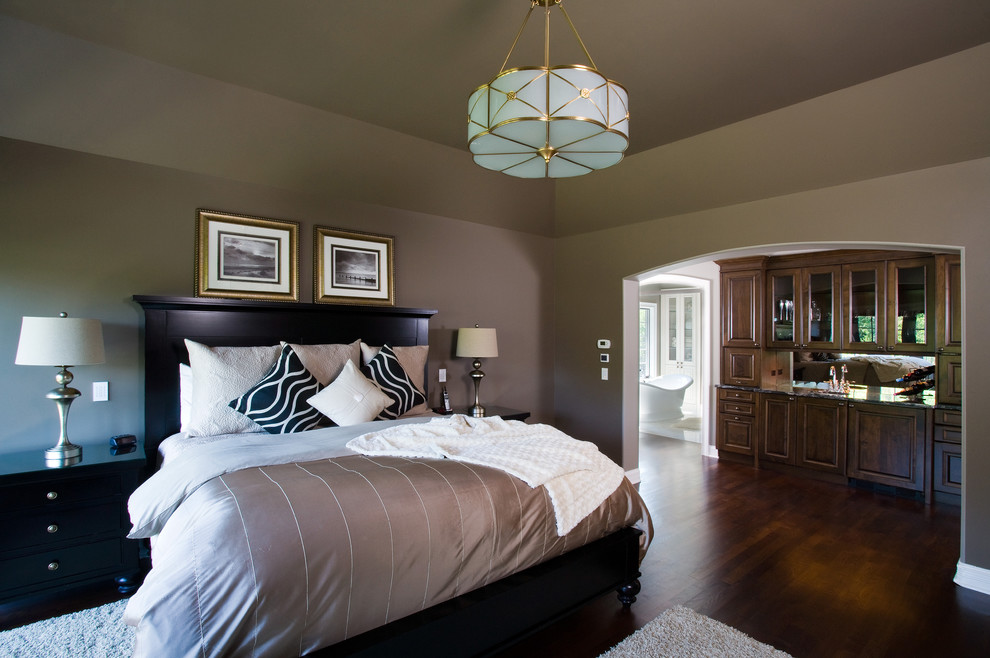 Large traditional master bedroom in Chicago with brown walls and dark hardwood floors.