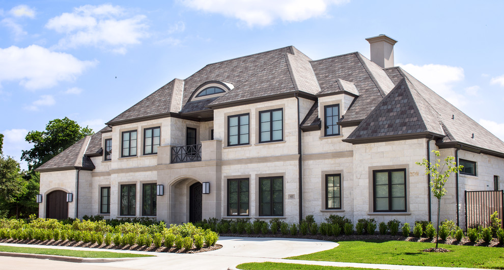Inspiration for a large transitional two-storey white house exterior in Dallas with stone veneer and a gable roof.