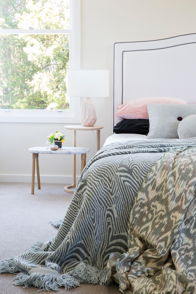 Contemporary master bedroom in Sydney with beige walls, carpet and beige floor.