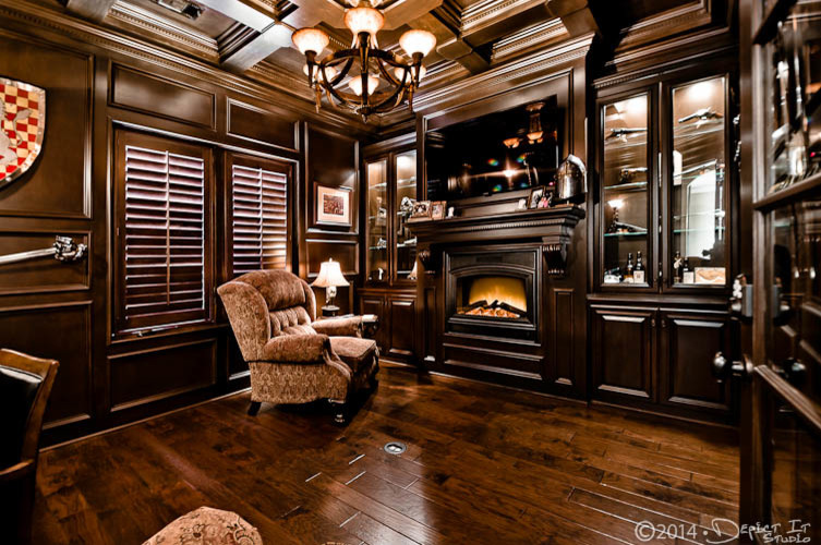 This is an example of a transitional study room in Other with a standard fireplace and a wood fireplace surround.
