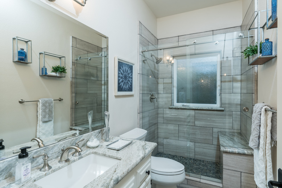 Design ideas for a beach style bathroom in Other with raised-panel cabinets, white cabinets, an alcove shower, gray tile, white walls, an undermount sink, a sliding shower screen and grey benchtops.