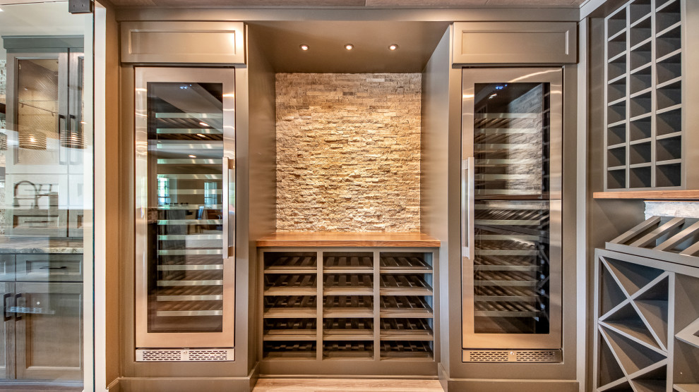 Inspiration for a large contemporary wine cellar in DC Metro with vinyl floors, display racks and brown floor.
