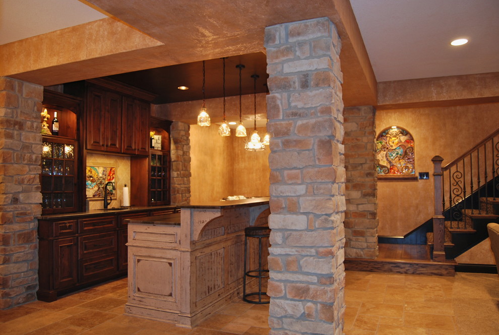 Design ideas for a large country fully buried basement in Kansas City with beige walls, travertine floors and no fireplace.