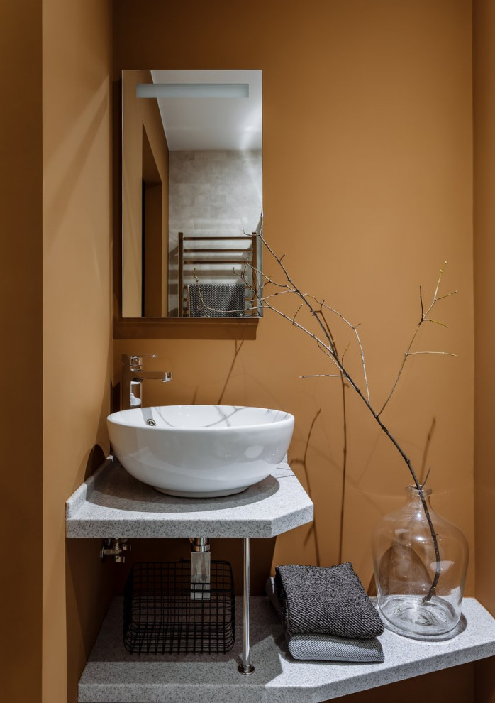 This is an example of a small midcentury 3/4 bathroom in Paris with a corner shower, a wall-mount toilet, brown walls, a vessel sink, granite benchtops, grey floor, a sliding shower screen, a single vanity and a floating vanity.