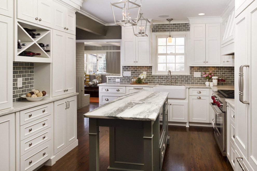 Enclosed kitchen - traditional u-shaped dark wood floor and brown floor enclosed kitchen idea in DC Metro with a farmhouse sink, recessed-panel cabinets, white cabinets, gray backsplash, subway tile backsplash, paneled appliances and an island