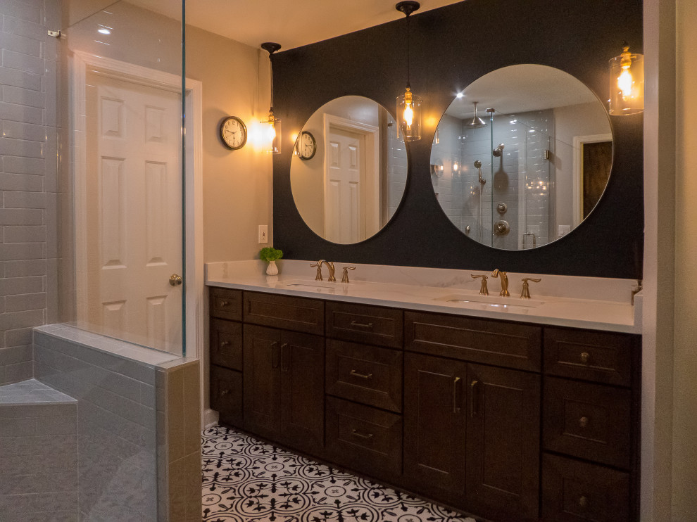 Photo of a mid-sized transitional master bathroom in Atlanta with shaker cabinets, brown cabinets, a claw-foot tub, a double shower, a two-piece toilet, gray tile, subway tile, grey walls, terra-cotta floors, an undermount sink, engineered quartz benchtops, multi-coloured floor, a hinged shower door and white benchtops.