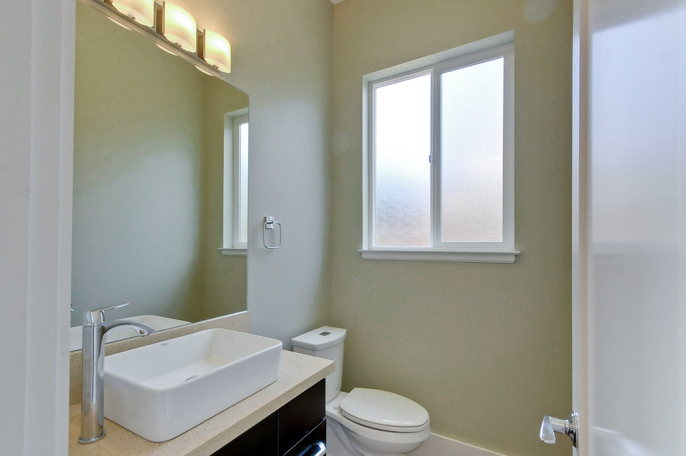 Photo of a small transitional 3/4 bathroom in San Francisco with flat-panel cabinets, dark wood cabinets, green walls, porcelain floors, a vessel sink and quartzite benchtops.