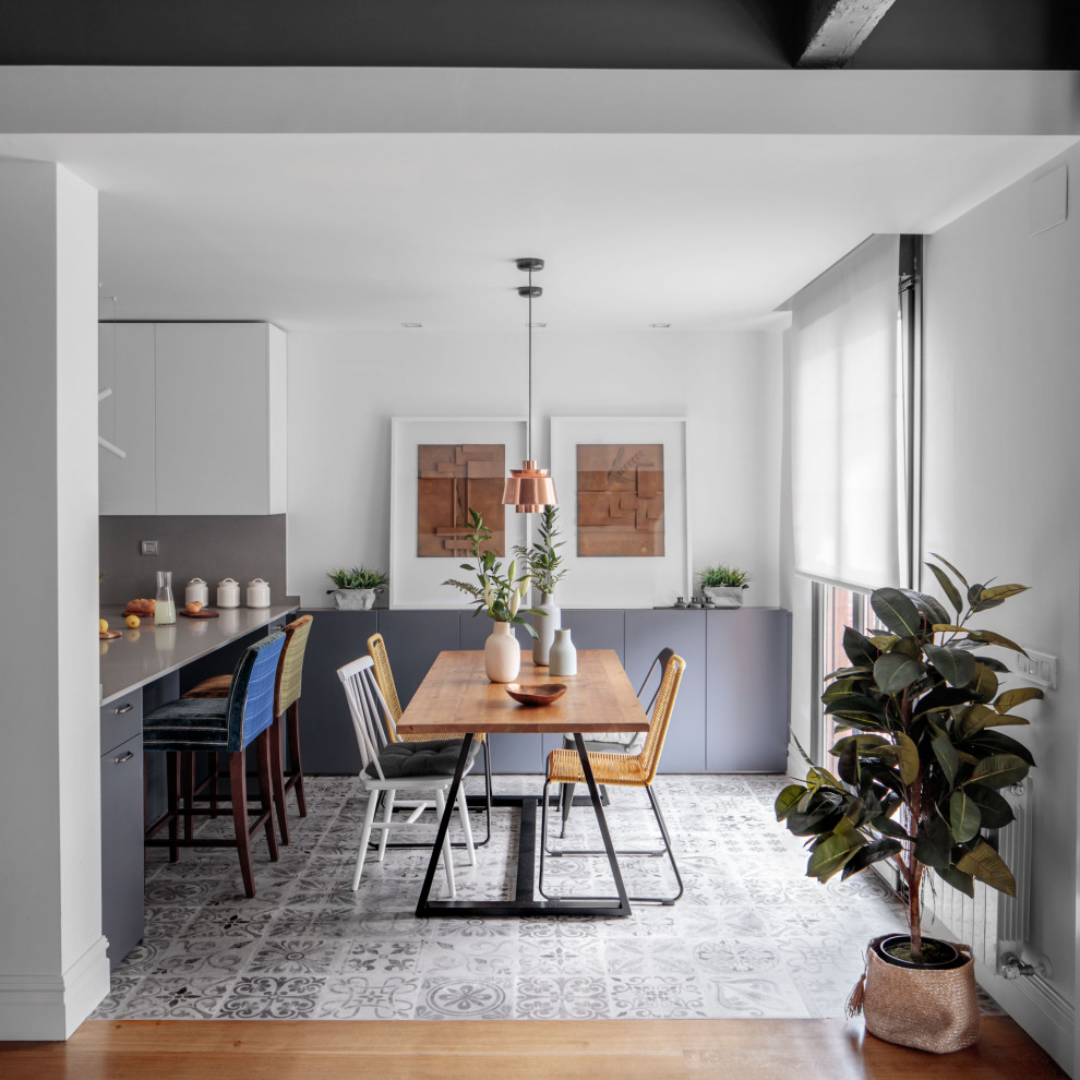 Photo of a mid-sized contemporary kitchen/dining combo in Other with white walls and grey floor.