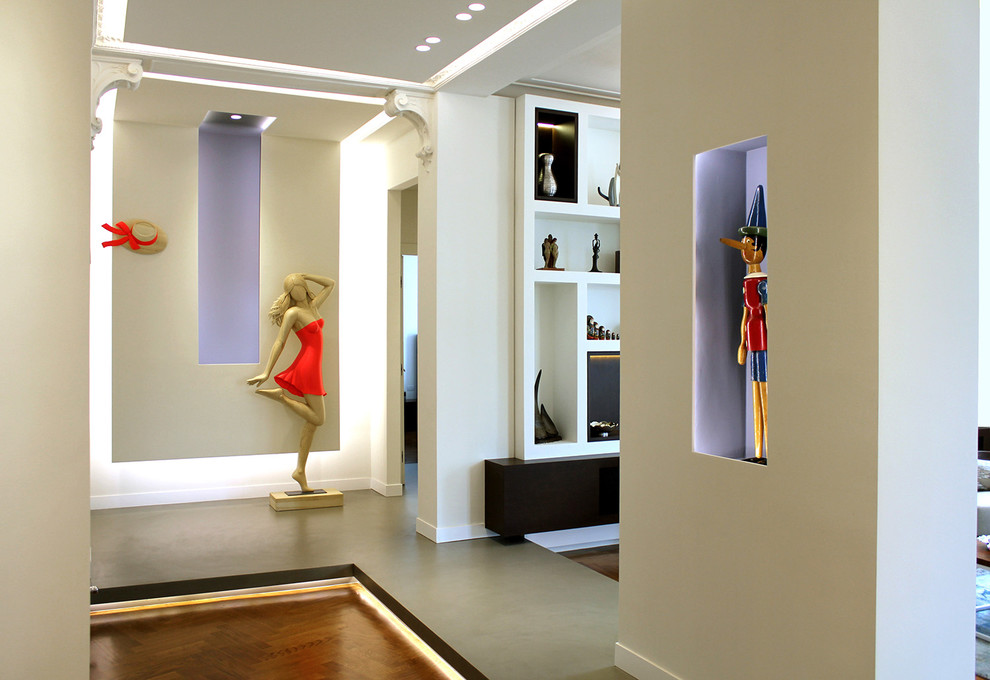 Photo of a large contemporary hallway in Turin with multi-coloured walls and medium hardwood floors.