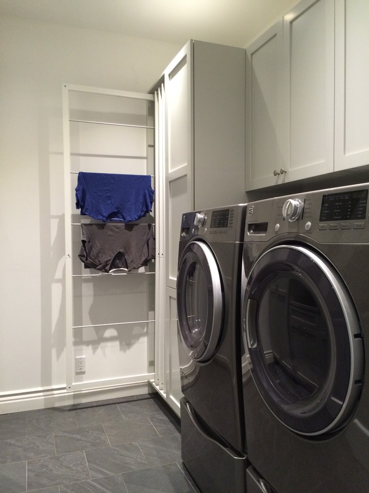 Photo of a contemporary laundry room in Milwaukee with white cabinets, white walls, a side-by-side washer and dryer and shaker cabinets.