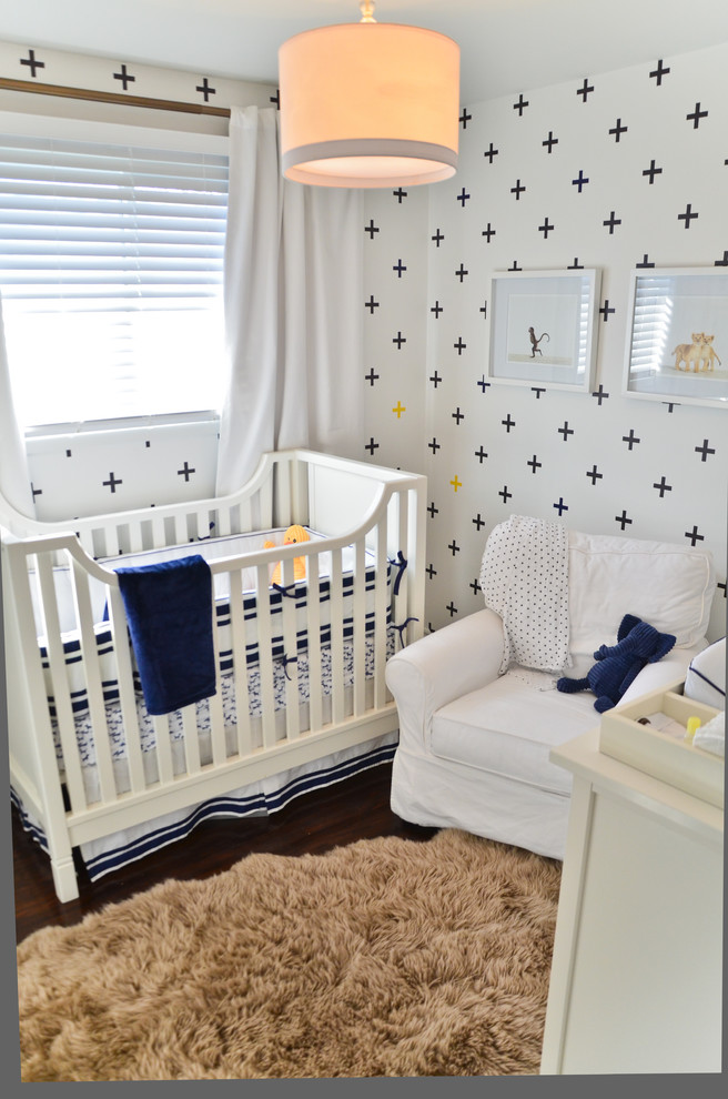 Design ideas for a small contemporary gender-neutral nursery in Toronto with white walls and dark hardwood floors.