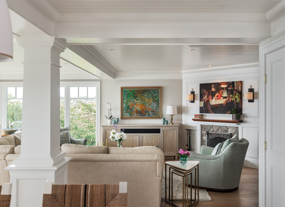 Arts and crafts open concept light wood floor and coffered ceiling living room photo in Boston with beige walls, a corner fireplace, a stone fireplace and a concealed tv